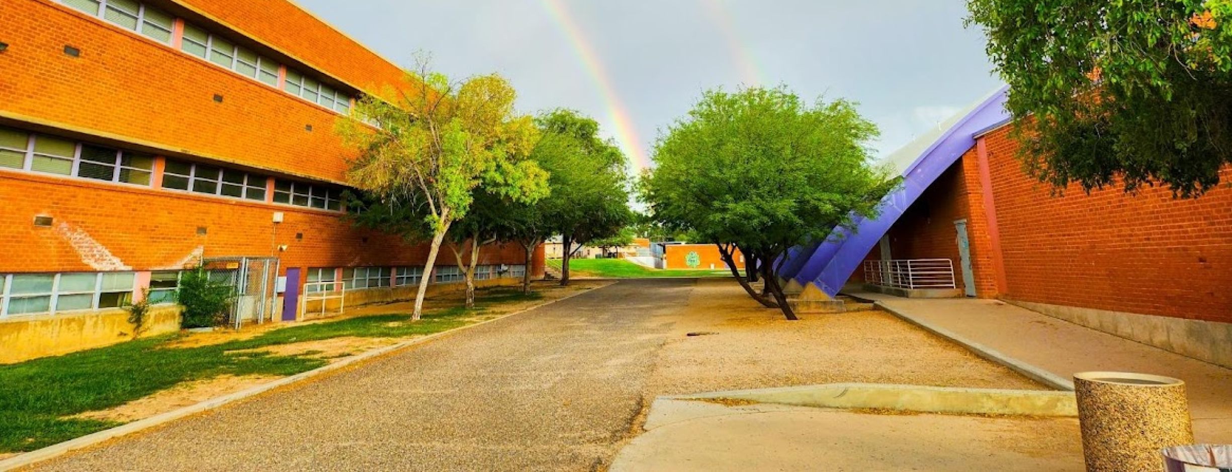 Building with rainbow behind it